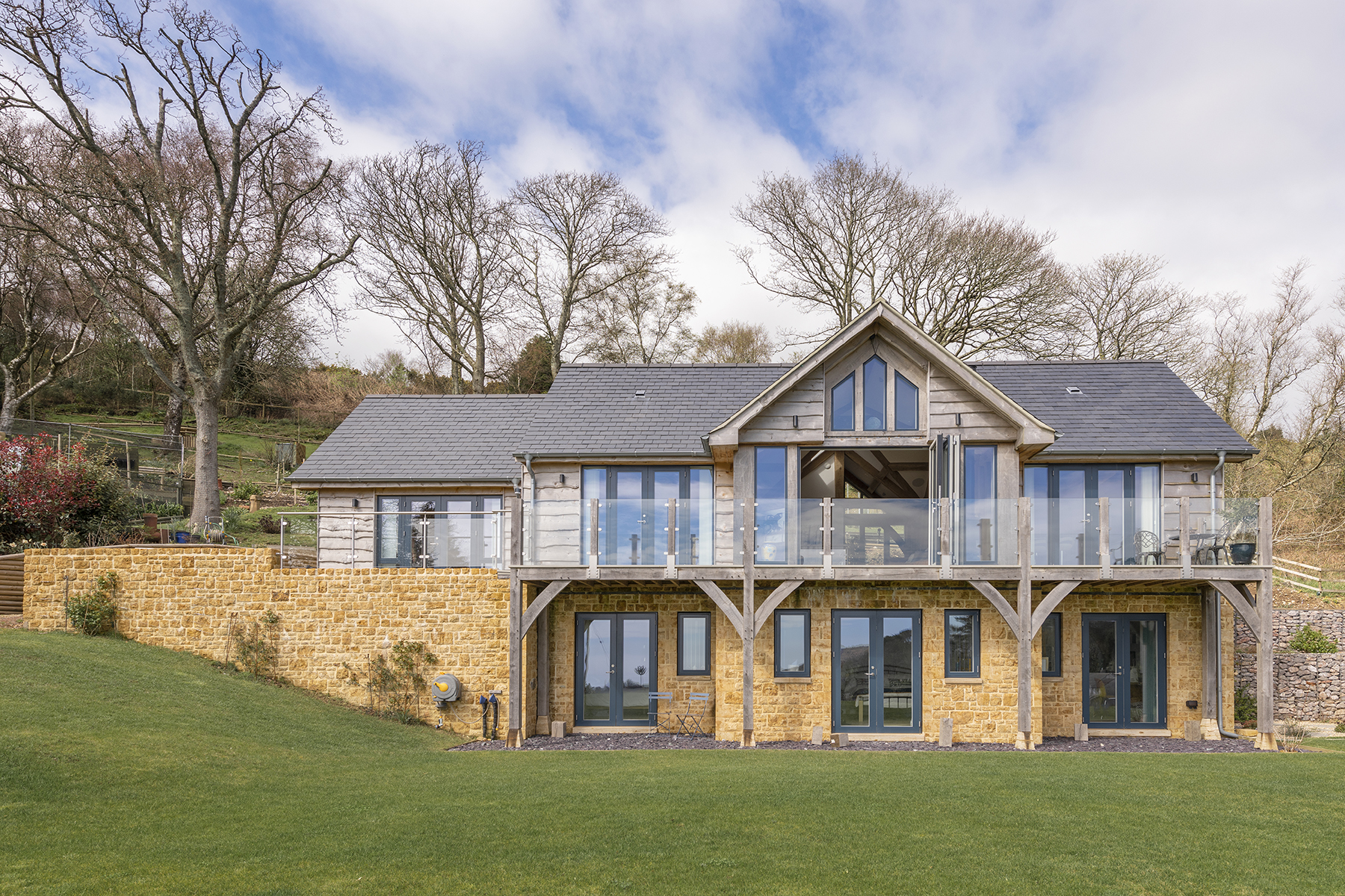 A large wooden house with an oak framed porch.